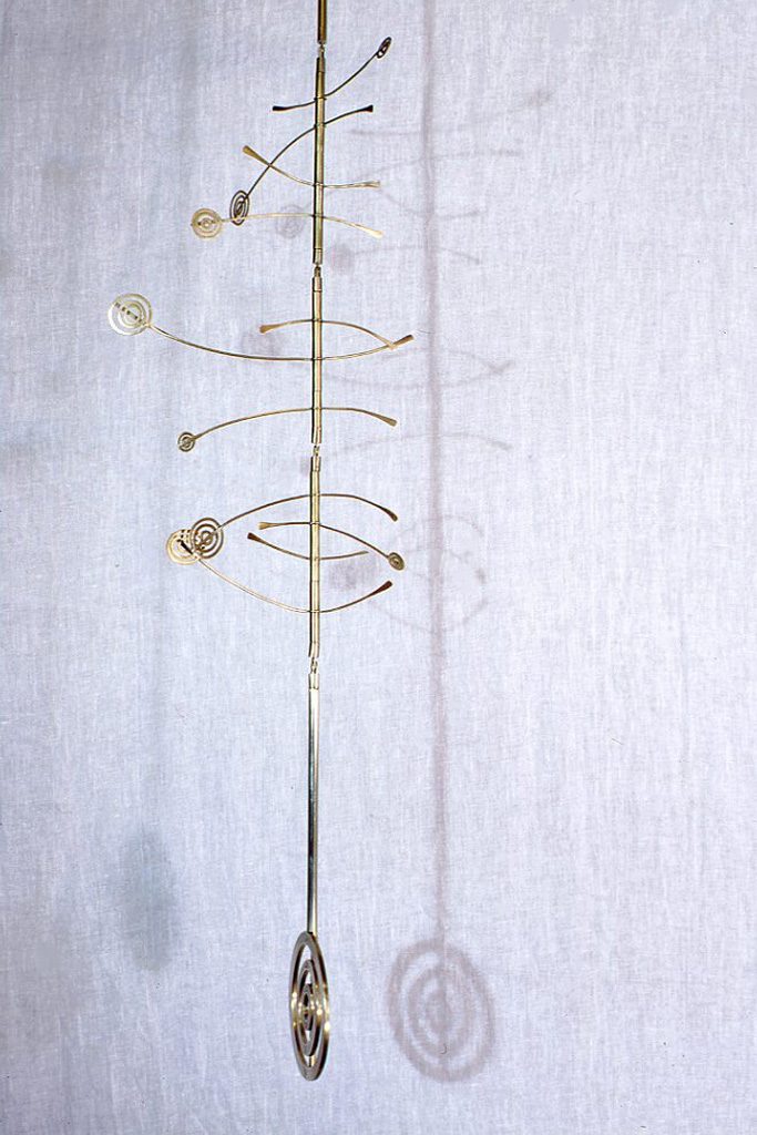 Hanging brass garden sculpture with concentric circle kinetic elements